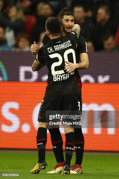 Lucas Alario of Leverkusen celebrates with Aranguiz of Bayer Leverkusen after he scored a goal to make it 1:0 during the Bundesliga match between...