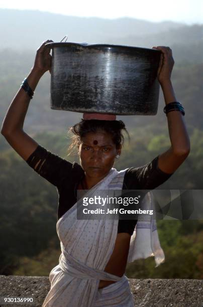 Woman carries water vessel balanced on head, Caves of Kanheri, India.