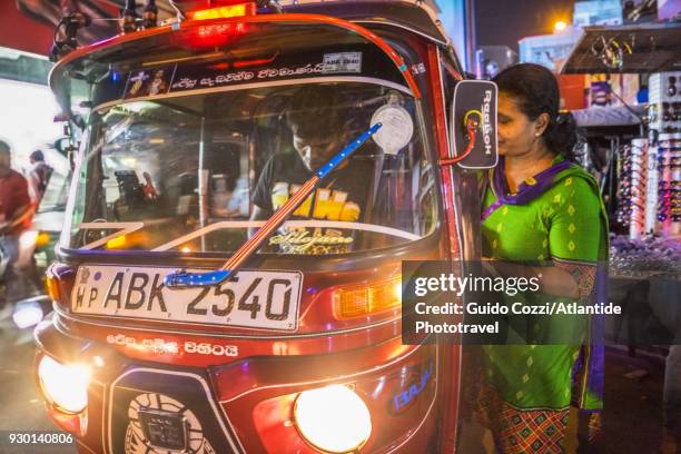 woman taking a tuk-tuk at pettah bazar - colombo stock pictures, royalty-free photos & images