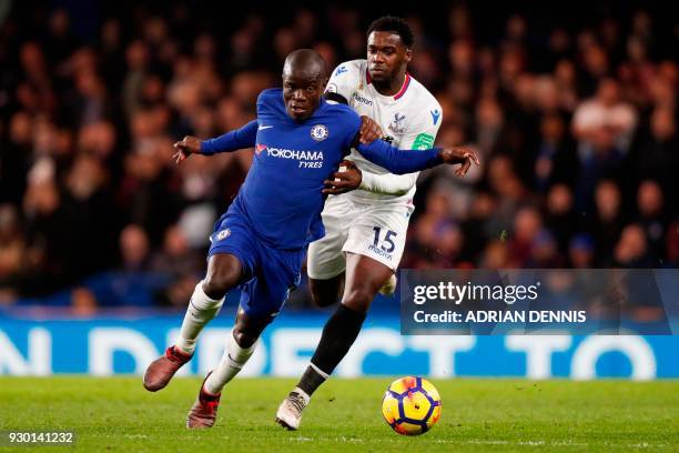 Chelsea's French midfielder N'Golo Kante takes on Crystal Palace's German midfielder Jeffrey Schlupp during the English Premier League football match...