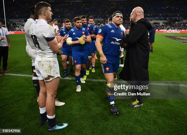 Guilhem Guirado of France and his team walk off the pitch after the NatWest Six Nations match between France and England at Stade de France on March...