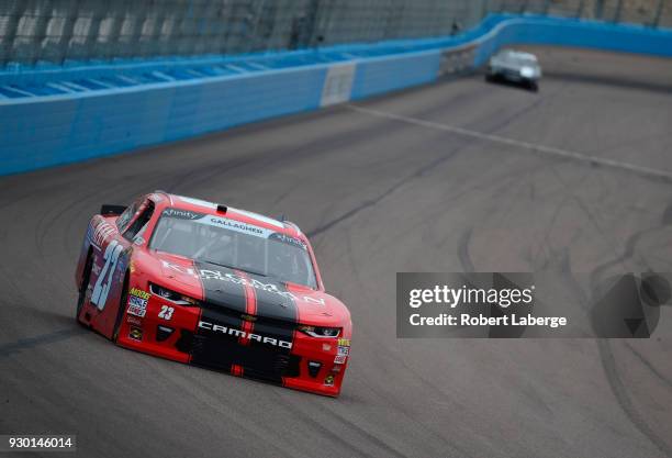 Spencer Gallagher, driver of the Kingman Chevrolet Chevrolet, races during qualifying for the NASCAR Xfinity Series DC Solar 200 at ISM Raceway on...