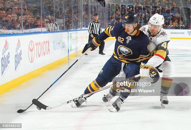 Nathan Beaulieu of the Buffalo Sabres controls the puck against Ryan Carpenter of the Vegas Golden Knights during an NHL game on March 10, 2018 at...