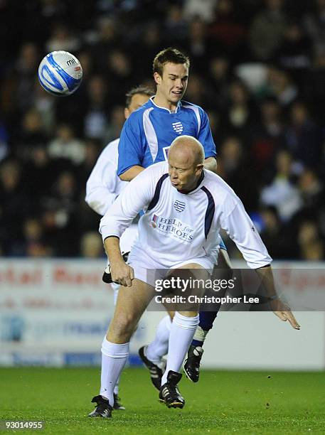 Mark Wright of England tackles Nico Mirallegro of Rest of the World during the Help for Heroes Cup match between England and Rest of the World at...