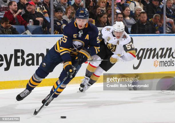 Rasmus Ristolainen of the Buffalo Sabres controls the puck against David Perron of the Vegas Golden Knights during an NHL game on March 10, 2018 at...