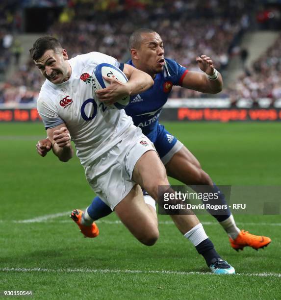 Jonny May of England breaks clear of Gael Fickou to score their try during the NatWest Six Nations match between France and England at Stade de...