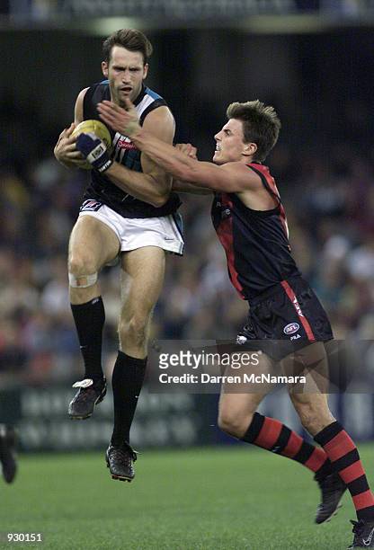 Darryl Wakelin for Port Adelaide takes the mark in front of Matthew Lloyd for Essendon, in the match between the Essendon Bombers and the Port...
