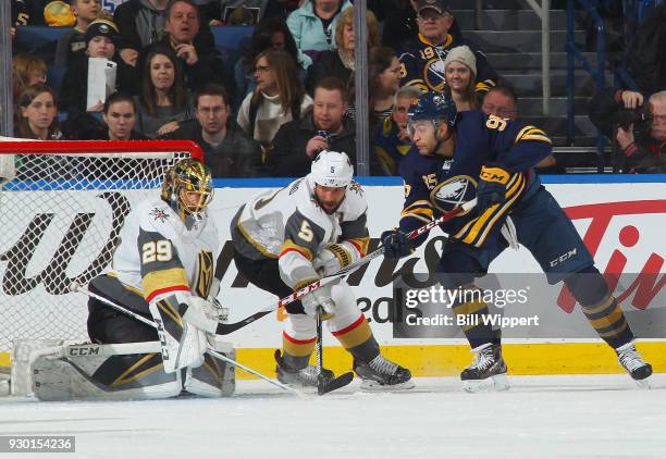 Justin Bailey of the Buffalo Sabres looks for a rebound while Deryk Engelland and Marc-Andre Fleury of the Vegas Golden Knights defend during an NHL...