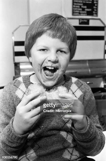 Battered jam butties are the specialty at the fish and chip shop on Railway Road, Chorley. A young boy is pictured enjoying the sandwich. March 1981.