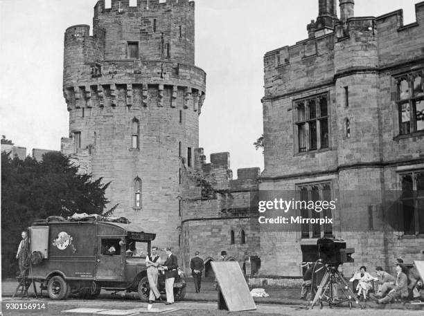 Cast and crew members of the British and Dominions Film Corporation seen here waiting for the sunshine at Warwick Castle. Where they are filming When...