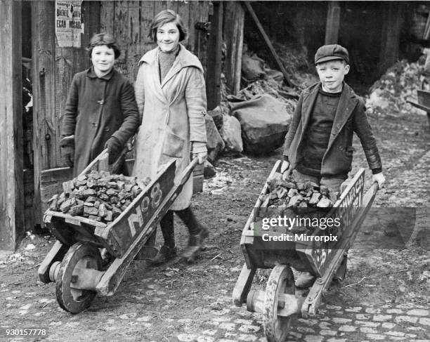 Children collecting their coal ration from a coal merchant near Birmingham City centre, 14th February 1940.