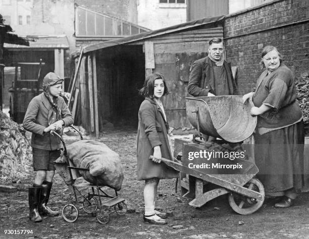 Children collecting their coal ration from a coal merchant near Birmingham City centre, 14th February 1940.