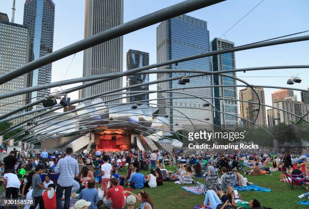 Millennium Park, crowd at Grant Park Symphony the Jay Pritzker Pavilion, a band shell designed by Frank Gehry, skyscrapers of the downtown on the...