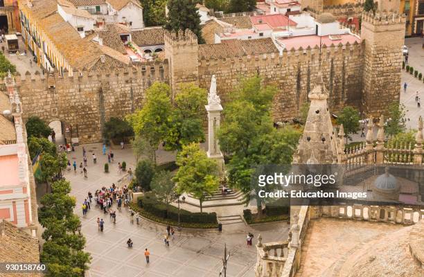 Seville, Seville Province, Spain, Aerial view over cathedral roof to Plaza del Triunfo and Alcazar Real.