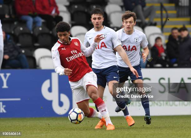 Xavier Amaechi of Arsenal takes on Anthony Georgiou and George Marsh of Tottenham during the match between Arsenal and Tottenham Hotspur at Meadow...