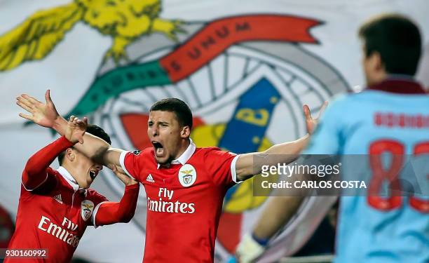 Benfica's defender Ruben Dias celebrates a goal with Benfica's Argentinian forward Franco Cervi during the Portuguese league football match between...