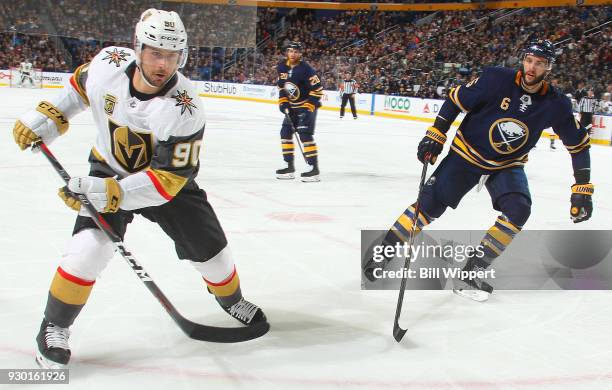 Tomas Tatar of the Vegas Golden Knights and Marco Scandella of the Buffalo Sabres battle for the puck during an NHL game on March 10, 2018 at KeyBank...