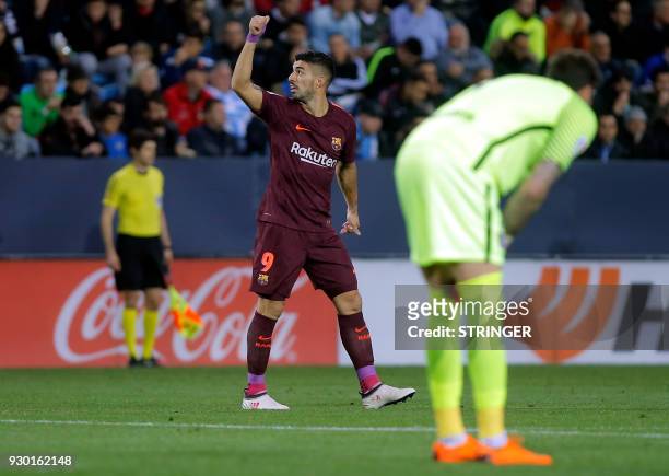 Barcelona's Uruguayan forward Luis Suarez celebrates a goal during the Spanish league football match between Malaga CF and FC Barcelona at the La...