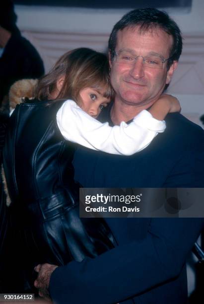 Actor Robin Williams holds his daughter Zelda as they attend the 'Jumanji' Culver City Premiere on December 10, 1995 at Sony Pictures Studios in...