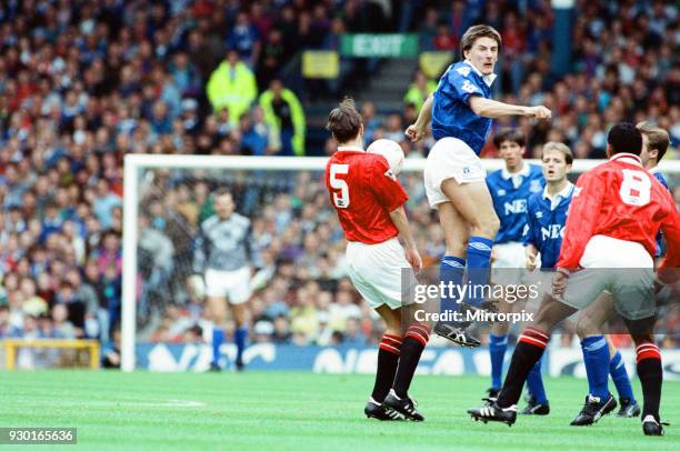 Everton 0-2 Manchester United, league match at Goodison Park, Saturday 12th September 1992. Peter Beardsley jumps for the ball, also pictured, Darren...