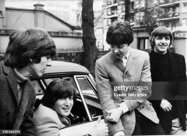 John Lennon passes his driving test in Weybridge Paul McCartney Ringo Starr and George Harrison are there to congratulate him, 15th February 1965.