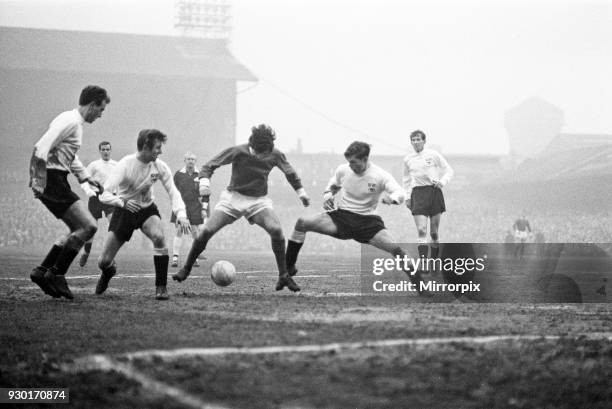 Manchester United footballer George Best in action to beat three defenders during the FA Cup third round match against Derby County at the Baseball...