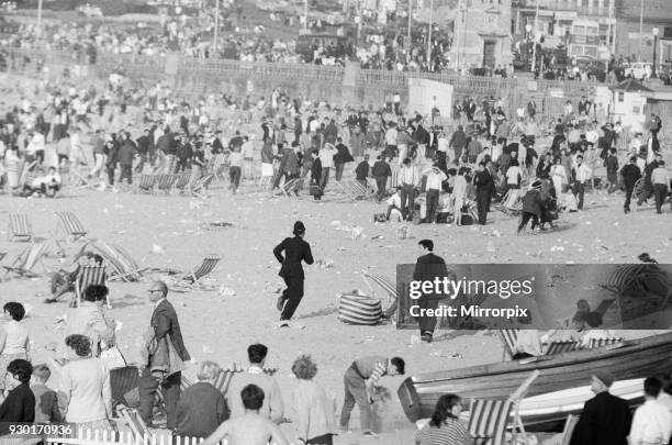 Mods v Rockers. Picture shows the scene at Margate, North East Kent in May 1964. The Police run across towards the Mods and Rockers to try and calm...