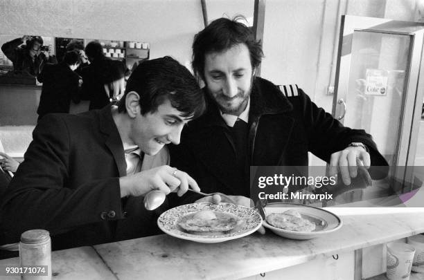 Pete Townshend, guitarist with British rock group The Who, pictured with actor Phil Daniels at a Shepherds Bush Pie and Eel Shop during the filming...