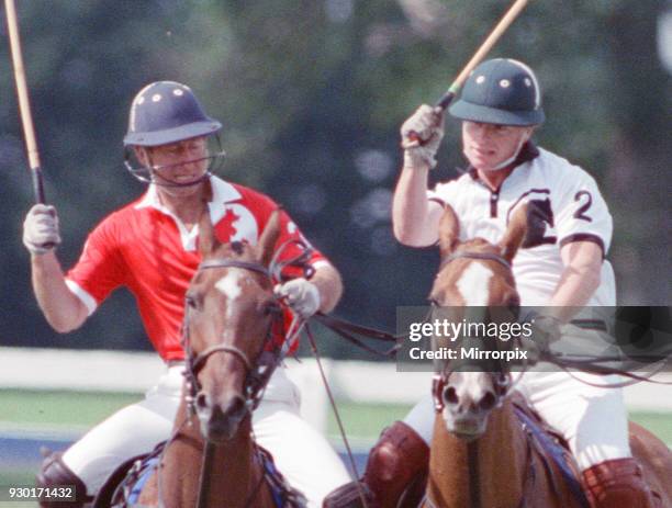 Prince Charles was locked in a fierce battle with Princess Diana's friend Major James Hewitt today , on the polo field. At one stage, as Major Hewitt...