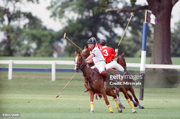 Prince Charles was locked in a fierce battle with Princess Diana's friend Major James Hewitt today , on the polo field. At one stage, as Major Hewitt...