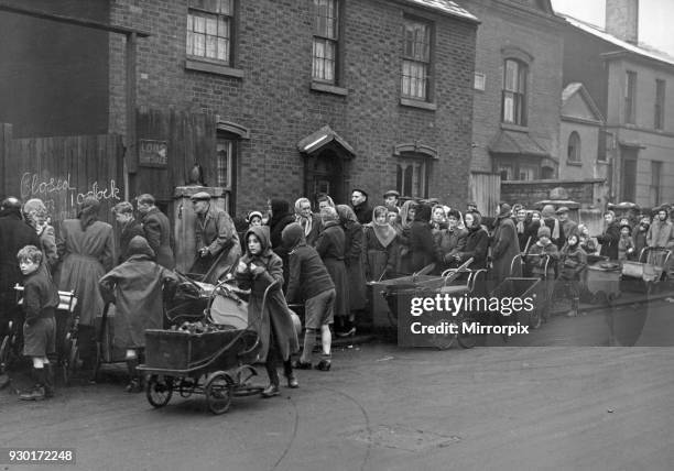 Residents of Birmingham queue with their prams at the Coal Merchants in Green Lane awaiting their allocation and hoping there is enough coal to go...
