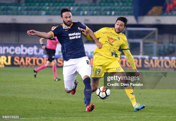 Lucas Castro of Chievo Verona competes with Simone Calvano of Hellas Verona during the serie A match between Hellas Verona FC and AC Chievo Verona at...