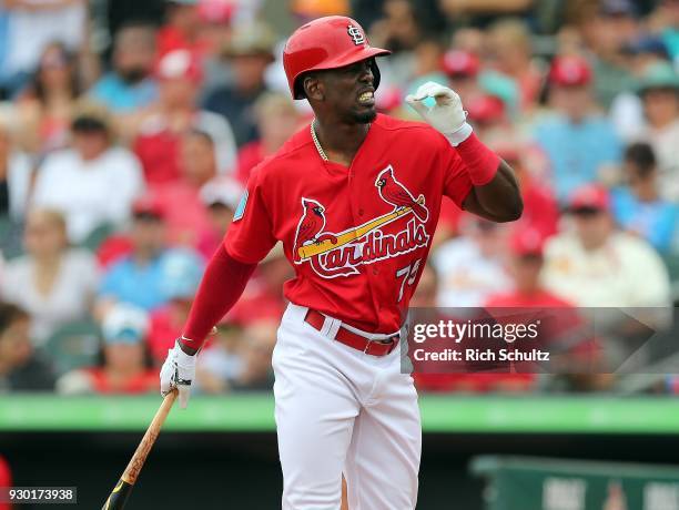 Adolis Garcia of the St. Louis Cardinals reacts to an inside pitch during the third inning of a spring training game against the Miami Marlins at...