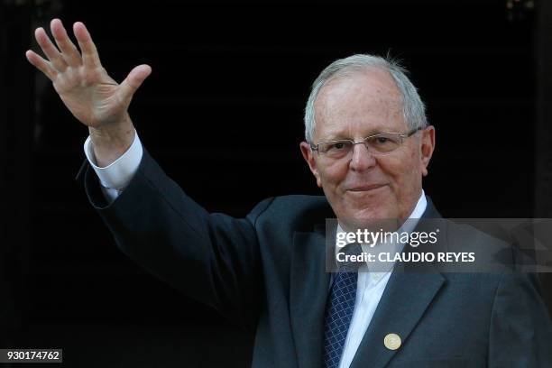 Peruvian President Pedro Pablo Kuczynski waves to the press upon arriving at the Diplomatic Academy in Santiago for a meeting with Chile's...