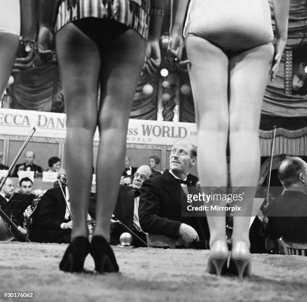 The Miss World beauty competition, held at the Lyceum in London. A violinist of the Norrie Paramor Orchestra admiring left to right: Miss Ghana, Star...