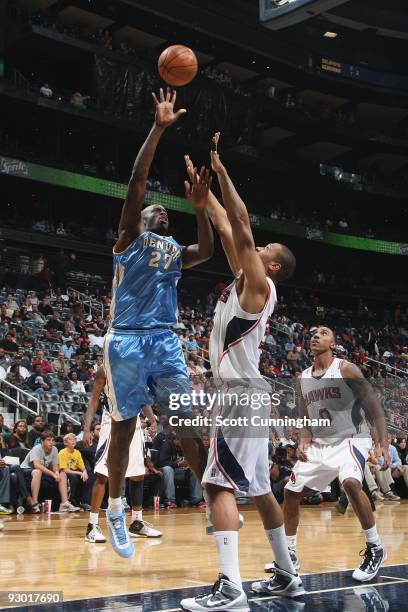 Johan Petro of the Denver Nuggets shoots over Randolph Morris of the Atlanta Hawks during the game on November 7, 2009 at Philips Arena in Atlanta,...