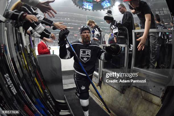 Jake Muzzin of the Los Angeles Kings high-fives fans before a game against the St. Louis Blues at STAPLES Center on March 10, 2018 in Los Angeles,...