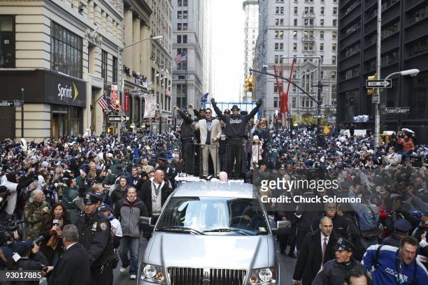 World Series: New York Yankees players Alex Rodriguez and Francisco Cervelli with celebrity rapper Jay-Z on float during ticker-tape during Victory...