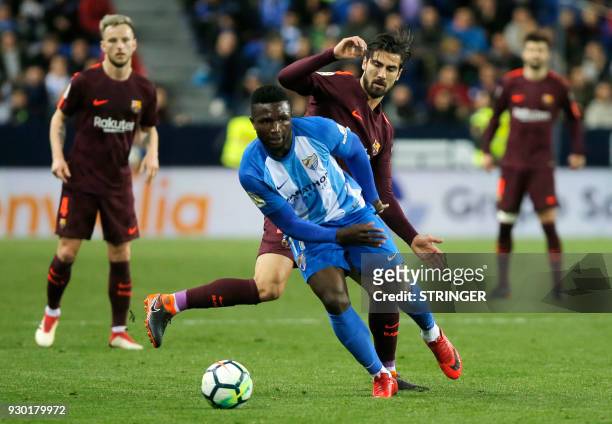 Malaga's Nigerian forward Isaac Success vies with Barcelona's Portuguese midfielder Andre Gomes during the Spanish league football match between...