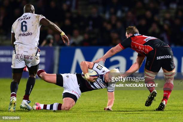Bordeaux-Begles' South African fly-half Tian Schoeman is tackled during French L1 football match between Bordeaux and Angers on March 10 at the...