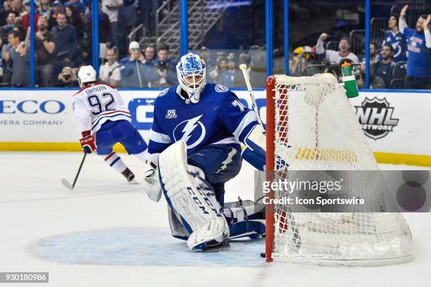 Montreal Canadiens center Jonathan Drouin skates away after scoring in the shootout as Tampa Bay Lightning goalie Louis Domingue collects the puck...