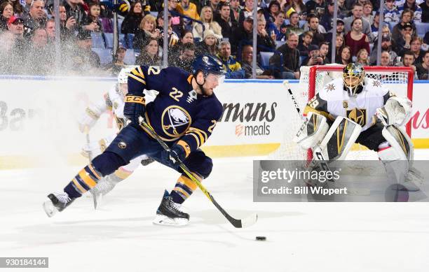 Johan Larsson of the Buffalo Sabres controls the puck in front of Marc-Andre Fleury of the Vegas Golden Knights during an NHL game on March 10, 2018...