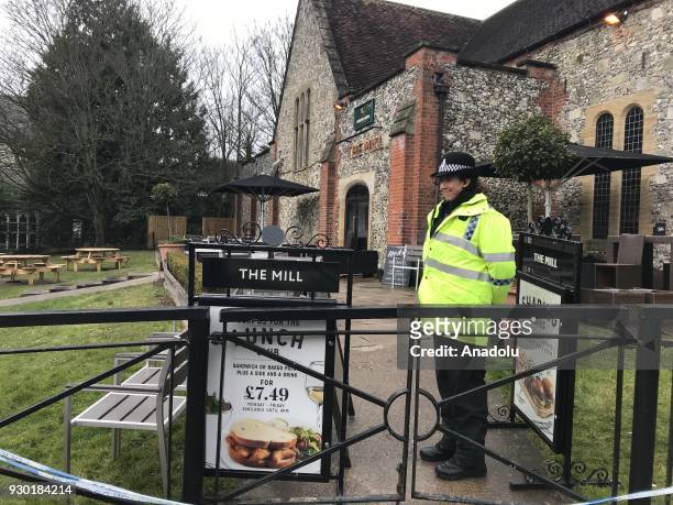 Police officials take security measures around the bar, a restaurant and the bench that former Russian spy Sergei Skripal and his daughter were found...