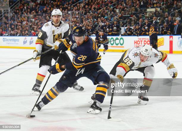 Zemgus Girgensons of the Buffalo Sabres controls the puck as Nate Schmidt of the Vegas Golden Knights defends during an NHL game on March 10, 2018 at...