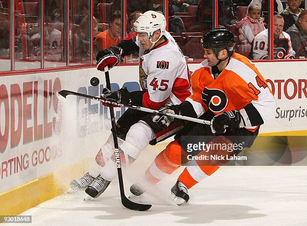 Ian Laperriere of the Philadelphia Flyers and Alexandre Picard of the Ottawa Senators battle for the puck at the Wachovia Center on November 12, 2009...
