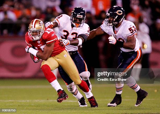 Michael Crabtree of the San Francisco 49ers runs after a catch as he is grabbed by Charles Tillman of the Chicago Bears at Candlestick Park on...