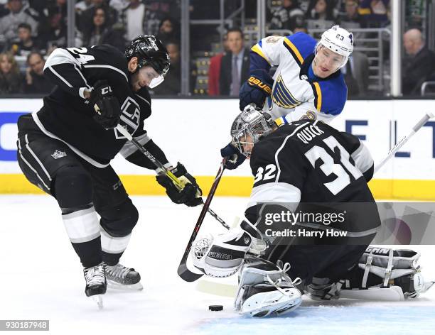 Jonathan Quick of the Los Angeles Kings makes a save as Dmitrij Jaskin of the St. Louis Blues and Derek Forbort look for the rebound during the first...