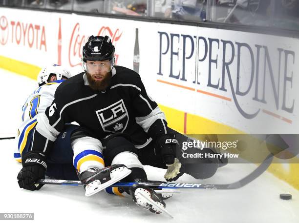 Jake Muzzin of the Los Angeles Kings looks for the puck as he falls to the ice with Vladimir Sobotka of the St. Louis Blues during the first period...