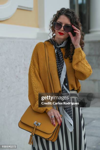Fashion Student Margarida Sousa wearing glasses from Primark, Skirt, scarf and sweater from Stradivarius, bag from Zara during the 50 edition of...