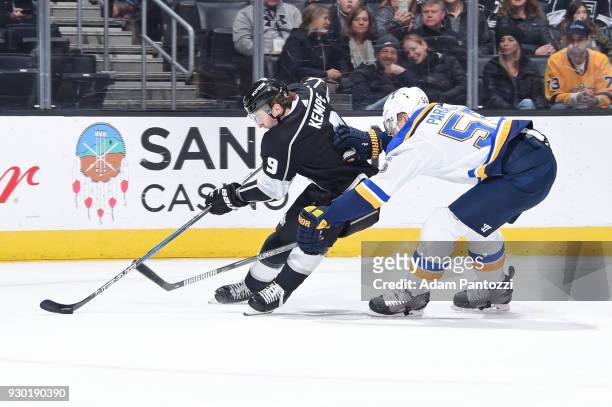 Adrian Kempe of the Los Angeles Kings handles the puck against Colton Parayko of the St. Louis Blues at STAPLES Center on March 10, 2018 in Los...